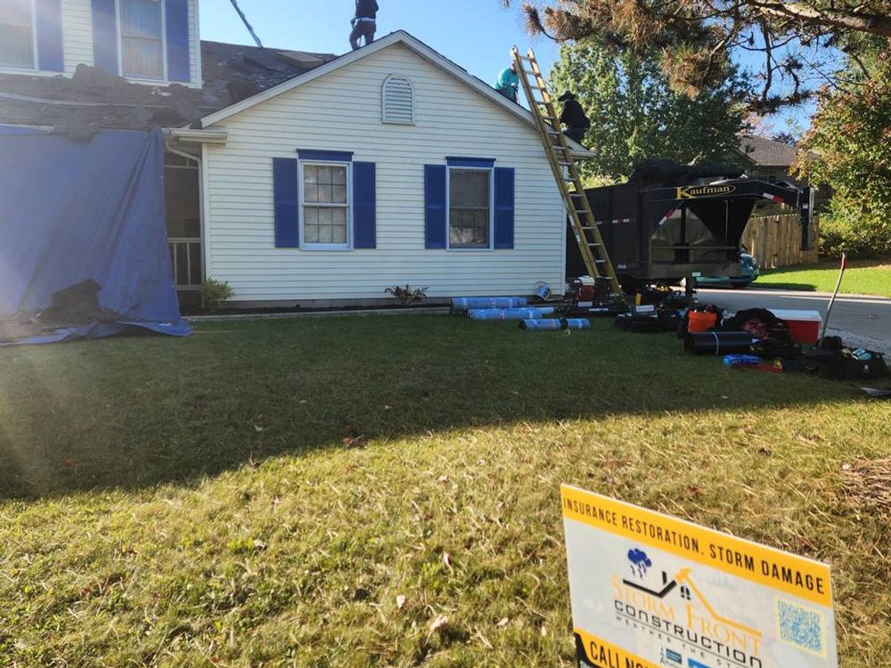 Completed roof replacement on a white home